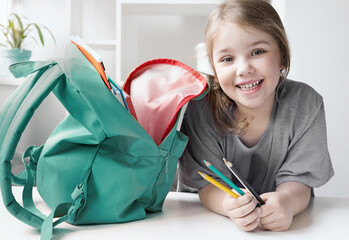 Caucasian child girl portrait with backpack.Back to school concept,school supplies.Schoolbag and...