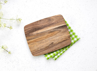 Kitchen wooden cutting board top view decorated with red picnic checkered cloth, serving dish empty space design, tableware on white. Food advertisement