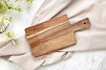 Cutting board top view, kitchen wooden tray decorated with towel cloth on white table.Food backdrop.