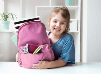 Caucasian child girl portrait with backpack.Back to school concept,school supplies.Schoolbag and pupil.