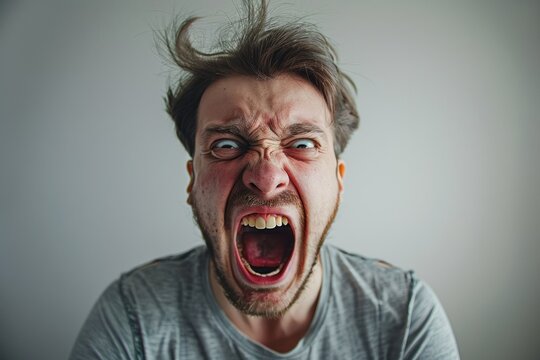 man is yelling with a fully open mouth