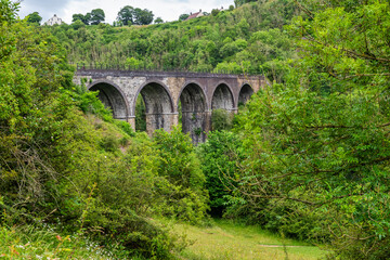 Fototapeta na wymiar Monsal Head and Monsal Dale and the old railway viaduct over the river Wye in the Peak District in Derbyshire, England