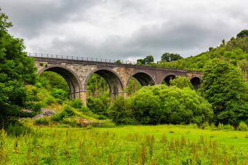 Monsal Head and Monsal Dale and the old railway viaduct over the river Wye in the Peak District in Derbyshire, England