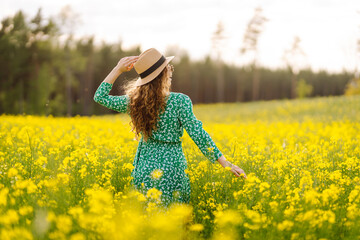 Beautiful woman walking in the field at sunny summer day. Nature, vacation, relax and lifestyle....