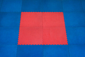 Traditional blue and red tatami of the martial arts hall as a background for text.