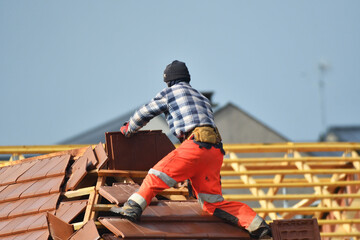 ouvrier couvreur sur un toit d'une construciion - 776162092