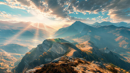 A panoramic view of a mountain range with a sun shining on the peaks