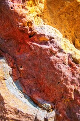 close up of the surface of a colorful stone outdoors