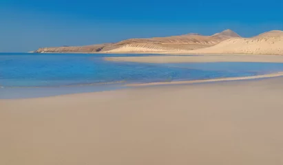 Fotobehang Sotavento Beach, Fuerteventura, Canarische Eilanden View of the coast of the Atlantic Ocean and the volcanic mountains peaks on a sunny day in Risco Del Paso -  Fuerteventura Island