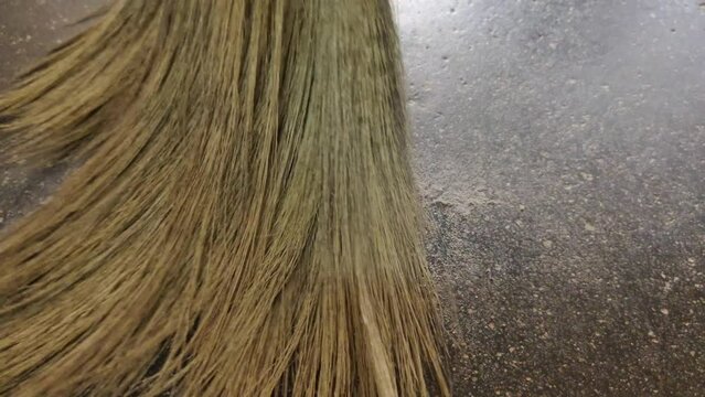 Hygiene equipment dry grass broom stick sweeping or cleaning dirty room floor dust. Hygiene, sanitary service job, work or occupation concept. Extreme close up macro view.