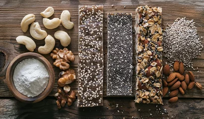 Tuinposter Variety of nuts and seed bars on a wooden surface. The concept of healthy eating and snacks. © volga