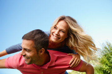 Couple, smile and blue sky on shoulders and sunny with trees, relationship or holiday with outside....