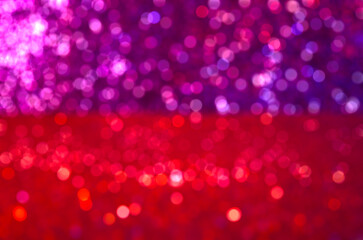 Red violet defocused bokeh light blur sparkling colorful background lights Golden sparks glowing...