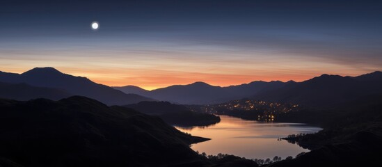Mercury and a new moon over Loughrigg in the Lake District - obrazy, fototapety, plakaty