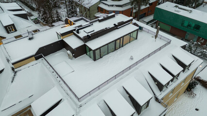 Drone photography of rooftop terrace covered by snow during winter evening
