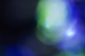 Defocused neon light. Overlay of light highlights. Futuristic LED lighting. Blur of neon colors on dark background