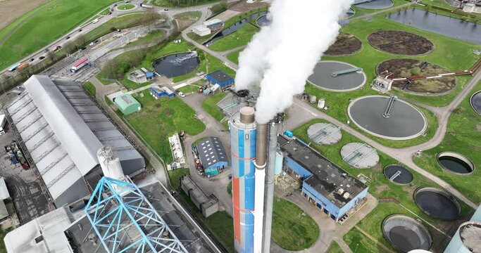 Aerial drone view on the smoke stack of a waste incineration plant. Smoke coming out of industrial waste processing plant. Duiven , The Netherlands.