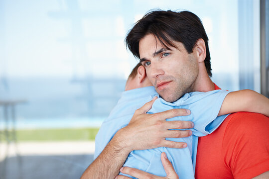 Father, hug and sleeping baby in outdoors with love, care, and affection at family house. Content, parent and young child asleep, bonding and together on vacation at childhood home for memory