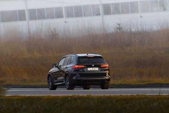 Poland, Europe 14.03.2024. Rear view of a black BMW x5 on the highway. High-performance German SUV