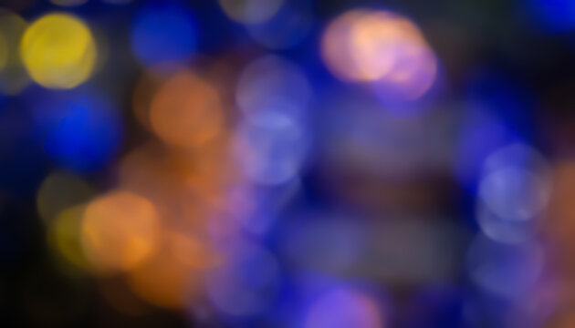 Defocused neon glow. Overlay of light highlights. Colorful bokeh. Futuristic LED lighting. Blur of colors on dark background