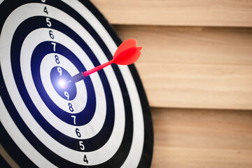 Red dart hitting on the target center dartboard, Business targeting or goal success and winner...