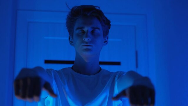 Sleeping young man walking around the room at night. Sleepwalking and sleep disorder concept