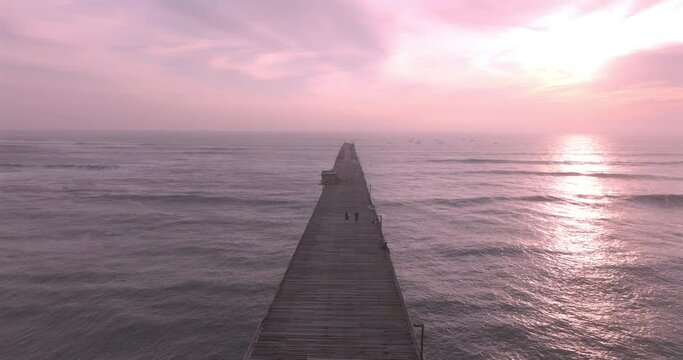 Shot of dock at sunset, with the seafront behind. Aerial shot of the Puerto Eten beach sea at sunset.
