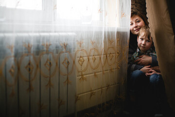 Portrait of a woman and child in their home. - 776202453