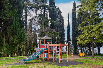 Empty children's playground on hill overlooking Lake Garda, Sirmione, Brescia, Lombardy, Italy - obrazy, fototapety, plakaty