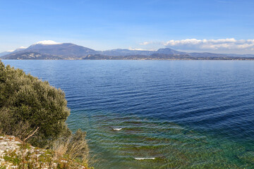 Elevated view of Lake Garda, famous tourist destination of Northern Italy, with the Monte Baldo...