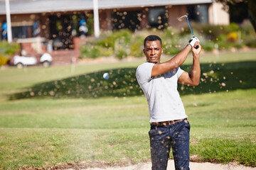 Man, golf ball and air with sand for sports, action and energy with club for game, competition and swing. Challenge, exercise and professional athlete with training, performance and leisure outdoor