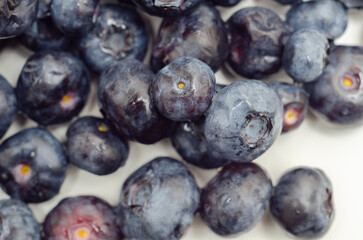 A bunch of blueberries are shown in a close up - 776210476