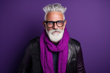 60 year old fashionable hipster man portrait on bright purple background