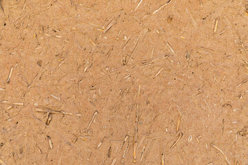 Patterns in a mud and straw adobe wall.