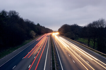 Aerial view of light trails along the M4 in Wiltshire, England at twilight