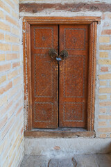 Decoratively carved wooden door at the Kalan Mosque in Bukhara. - 776226257