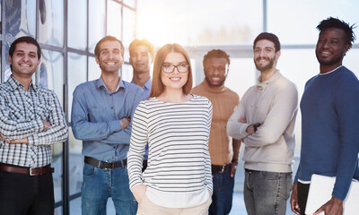 Business people in elegant casual clothes are standing in the office