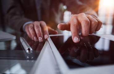 close up. businessman pressing his finger on the screen of the digital tablet