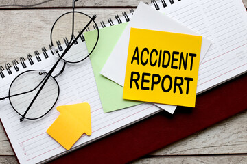 Accident report text on a yellow sticky note on a diary