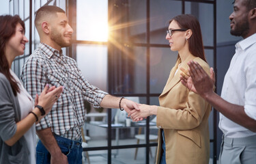 Businessman shaking hands with colleague after meeting in office