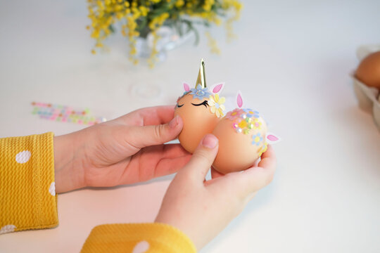 Children's hands decorate Easter eggs. Happy Easter.