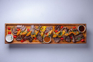 Top view Rustic wooden platter with assorted meats and vegetables