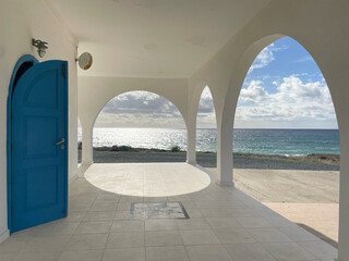 Vorhalle der Ayia Thekla Kapelle mit weißen Bögen und blauer Tür bei Ayia Napa, Zypern