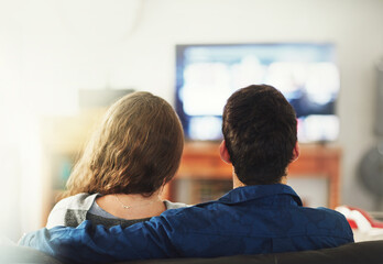 Couple, relax and hug on sofa for movie or quality time on weekend, embrace and love with...