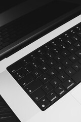 A designer's laptop. Close-up of a keyboard in black and white - 776271890