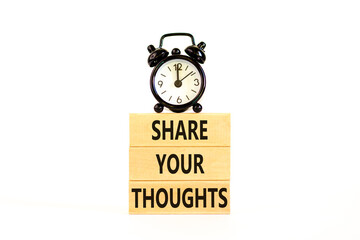 Share your thoughts symbol. Concept words Share your thoughts on beautiful wooden blocks. Beautiful white table white background. Black alarm clock. Business share your thoughts concept. Copy space.