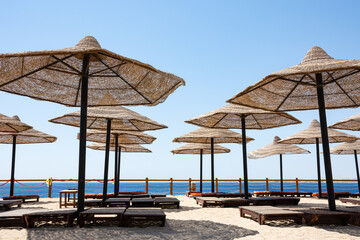 View from a sunbed under a straw umbrella to the Red Sea from the beach in the Egyptian resort town of Sharm el-Sheikh