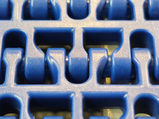 A close-up of a blue polyurethane belt in modular industrial conveyor system. Transport systems in...