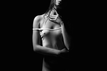 Sexy woman in wet shirt. Beautiful body Girl in the dark - obrazy, fototapety, plakaty