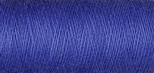 macro texture of a skein of blue sewing thread